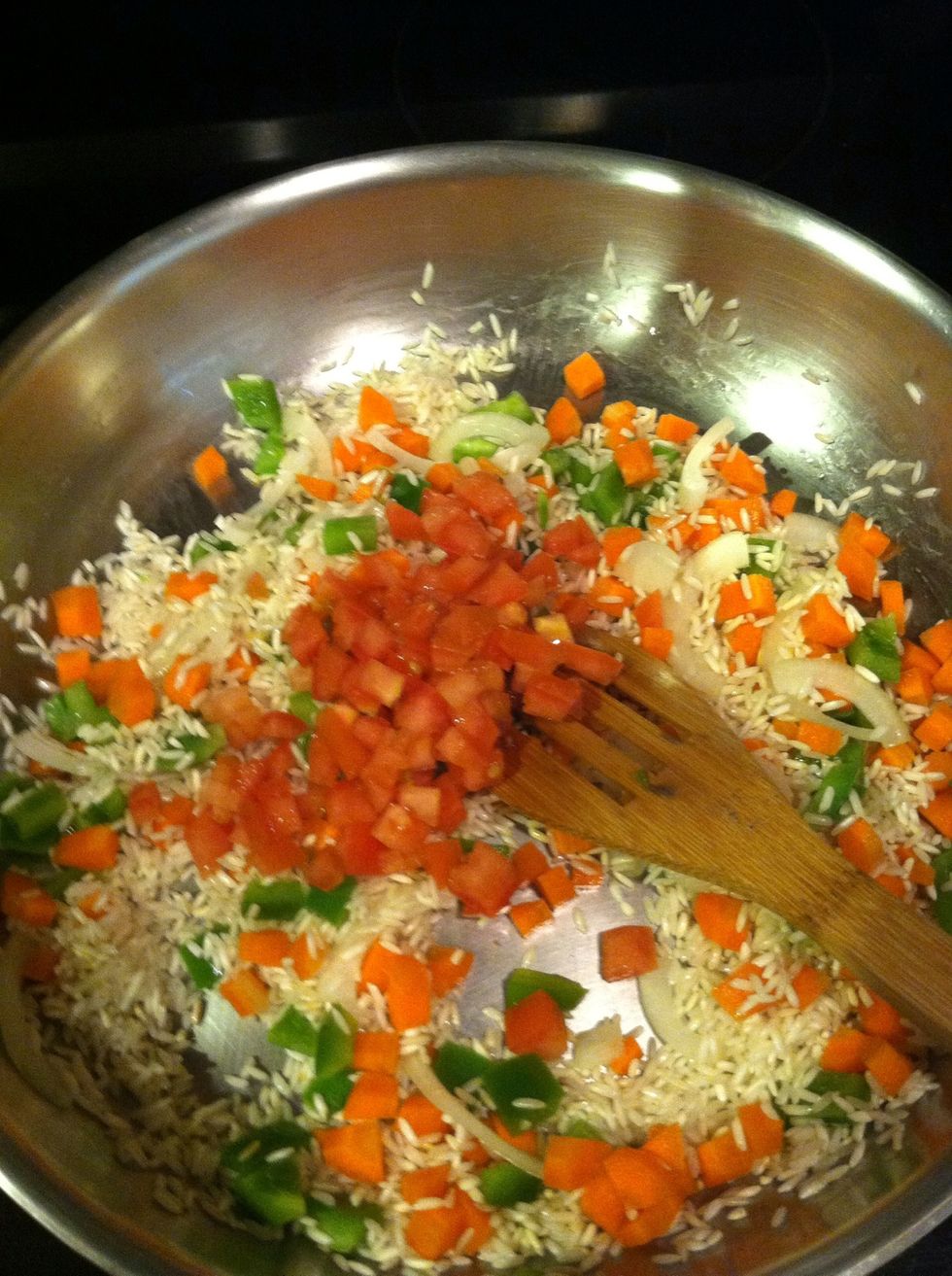 Add your tomato, and saut\u00e9 for another minute or so