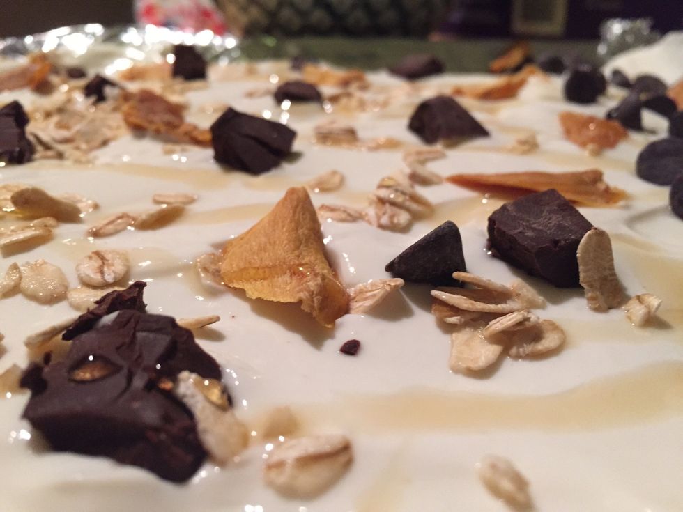 Add your toppings. I did chocolate chunks, oats, dried mango and a drizzle of honey. Other ideas: granola, fruit, jam, Cheerios... The possibilities are endless!