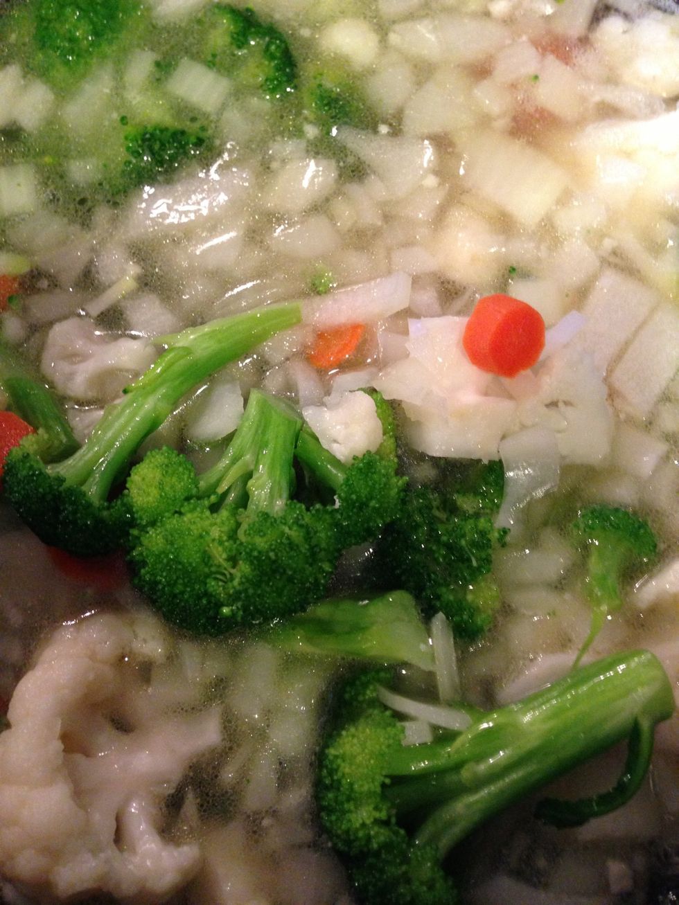 Add your vegetables to the boiling chicken stock.
