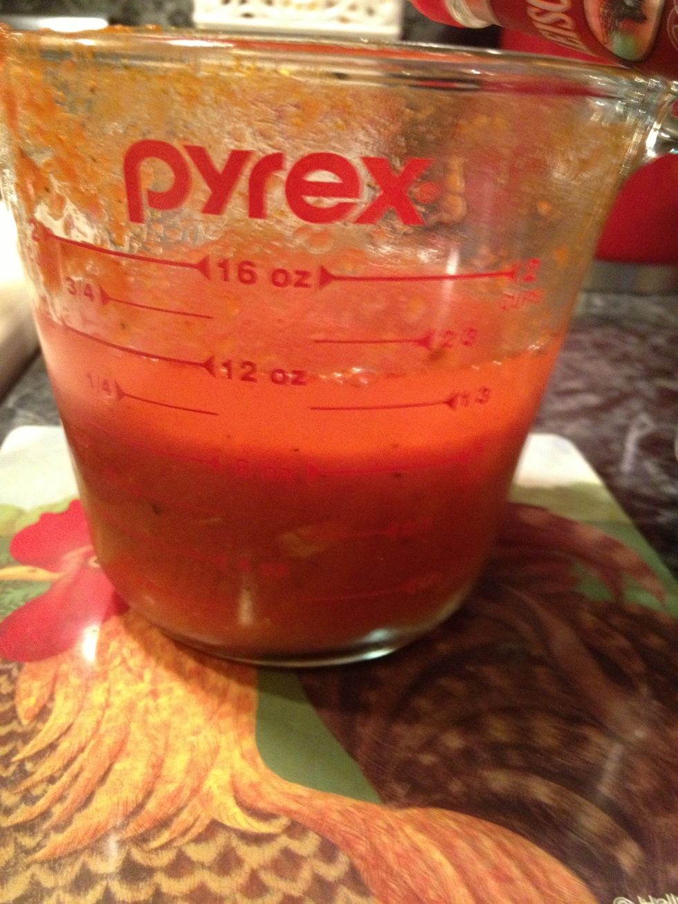 Add your vodka to the marinara sauce. I used my marinara sauce, you can use homemade or a store bought jar of marinara sauce.