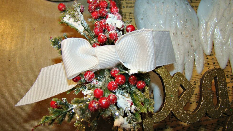 Add your wings to the box and apply some Christmas sprigs and a pretty bow.