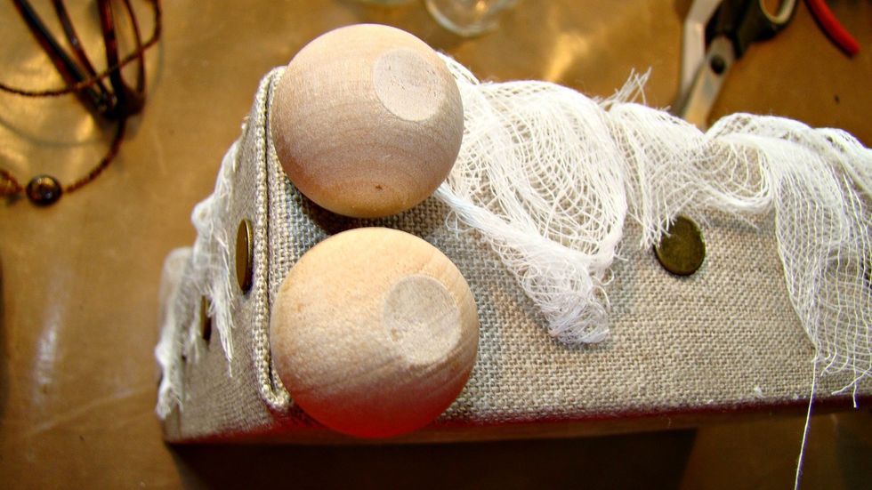 Add your wooden balls to bottom of canvas for feet.