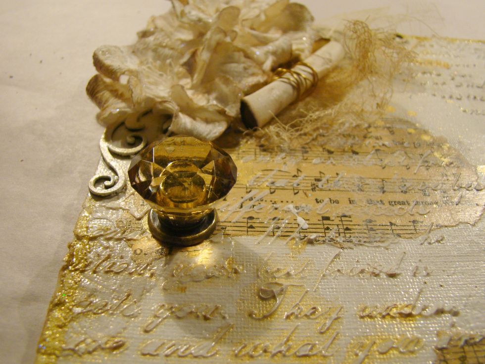 Added 7 Gypsies door knob to bottom of canvas and attached jump rings with asst. baubles and key.
