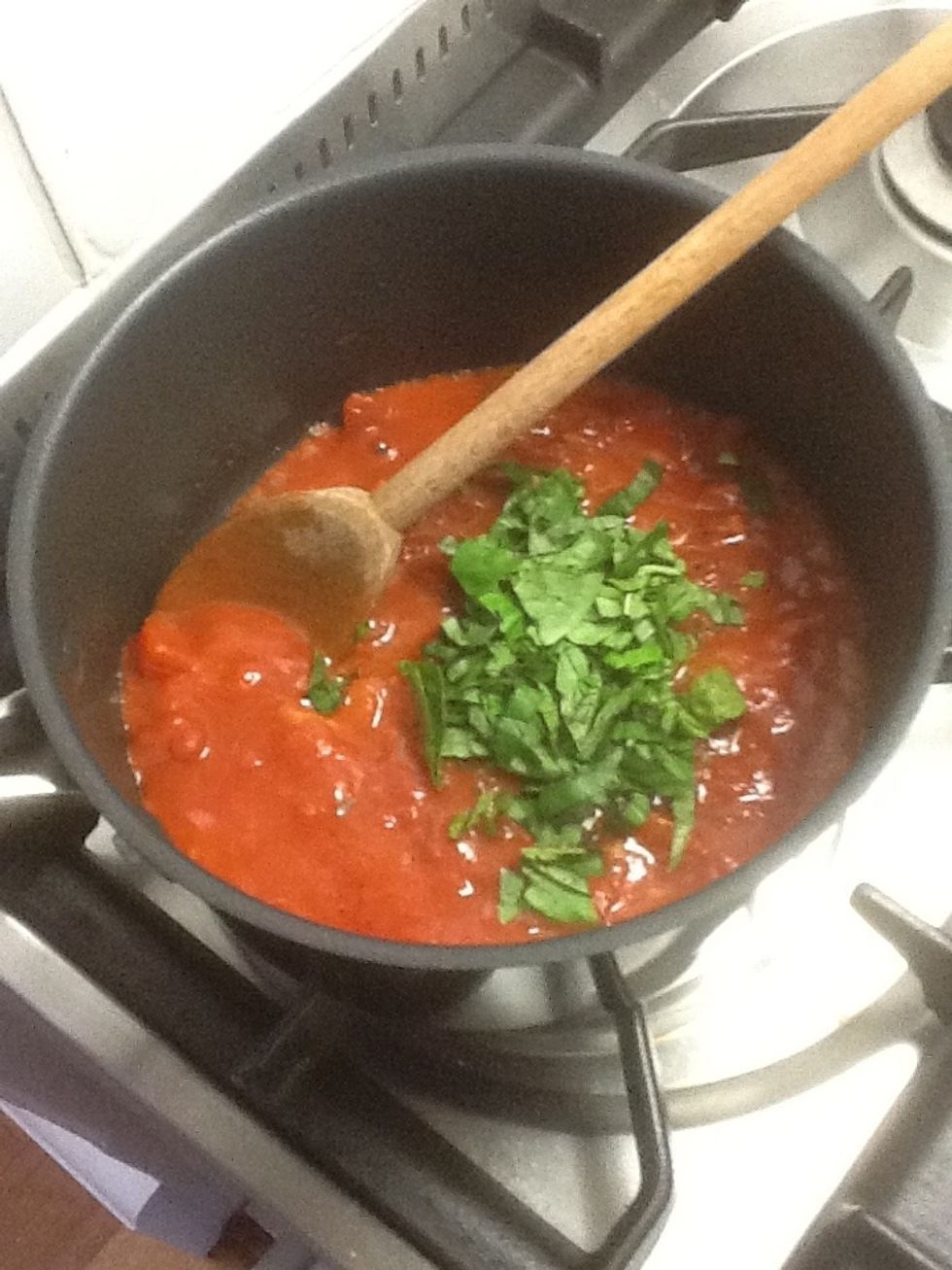 Added diced tomatoes, sugar, vegetable stock, black pepper and basil leaves. Simmer till mixture thickens.