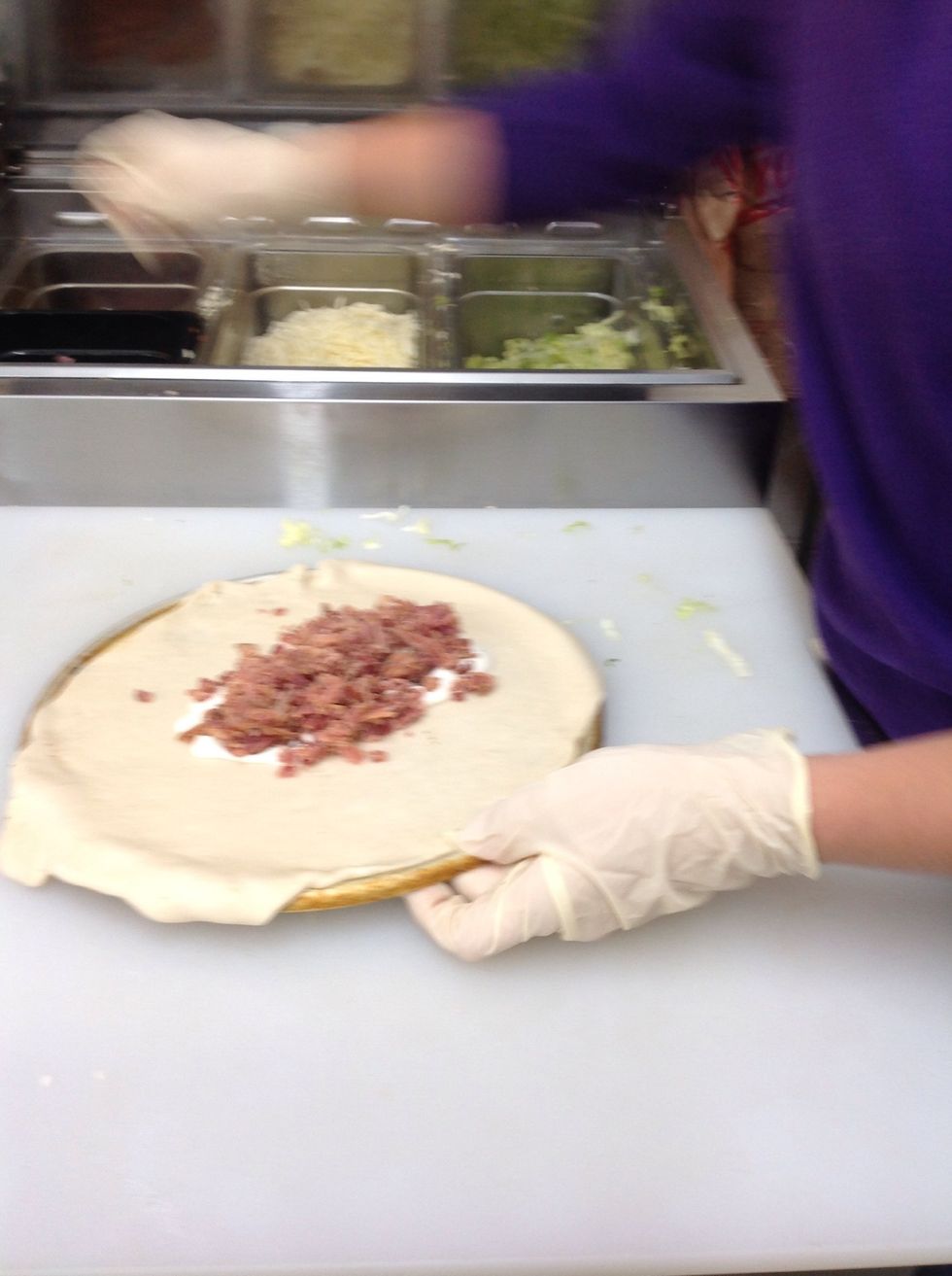 Adding bacon onto the calzone