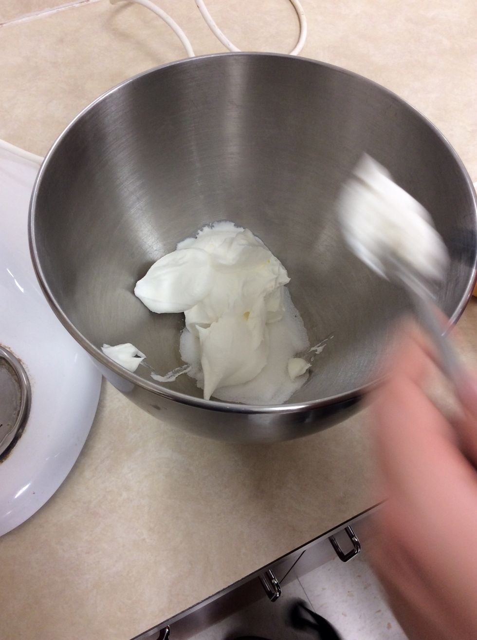Adding the whip cream and sugar together.