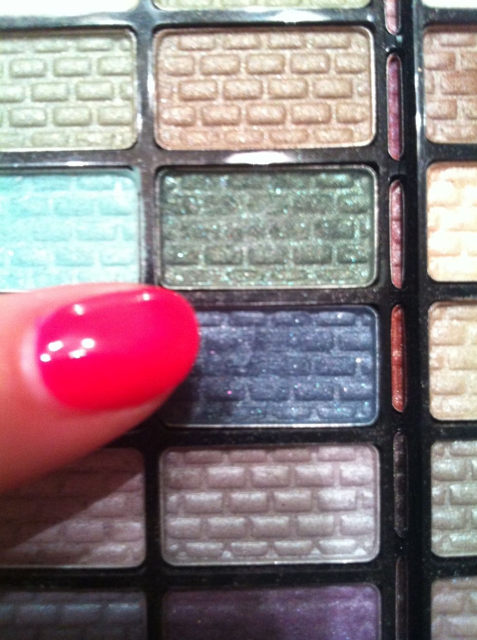 Adding to the contouring effect to further enhance this Taylor Swift effect, I'm applying a dark blue eyeshadow. (dark green will work as well)