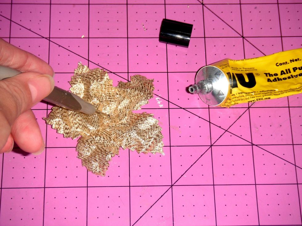 Adhere 5 gold leaves together shaping them like a poinsettia. Use a permanent adhesive. Press and let dry.