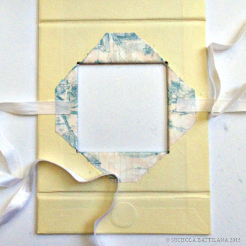 Adhere a 12" length of ribbon to both sides of the window as shown.