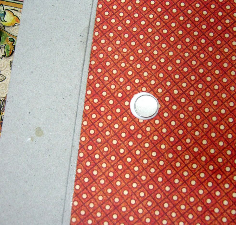 Adhere a magnet to the right front cover 3 inches from the edge.