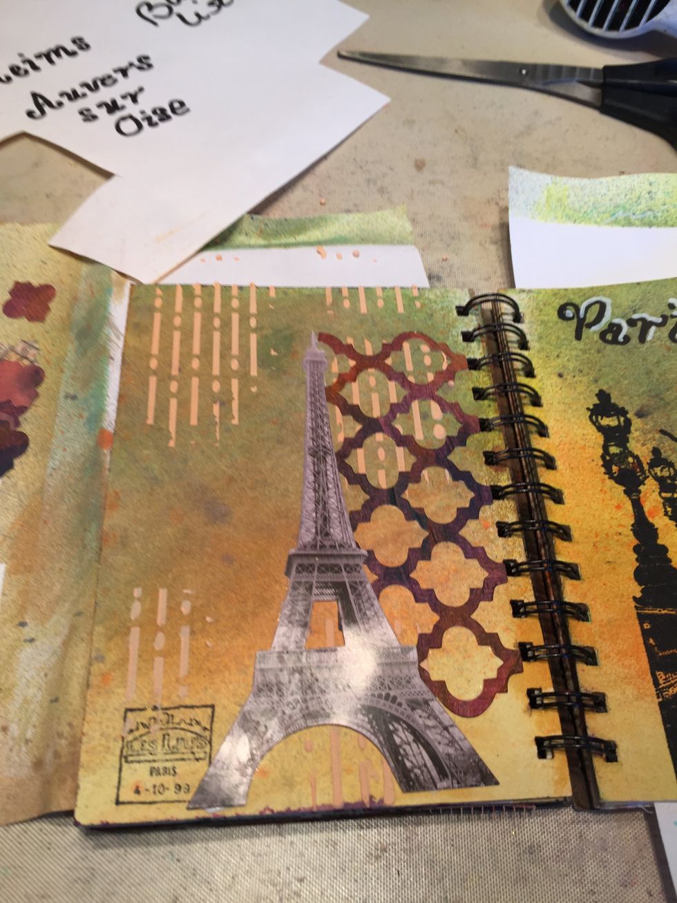 Adhere a picture of the Eiffel Tower to the page, overlapping the trellis.