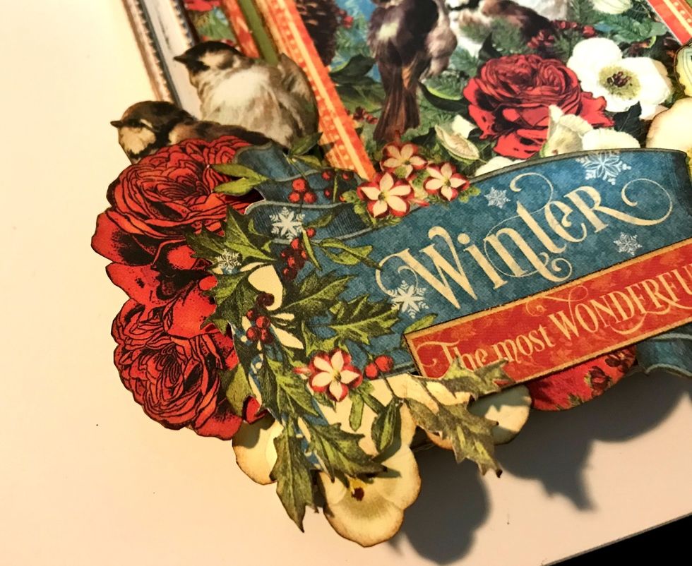 Adhere a two rose bunch, two birds and one white flower on the top left side of the winter banner.
