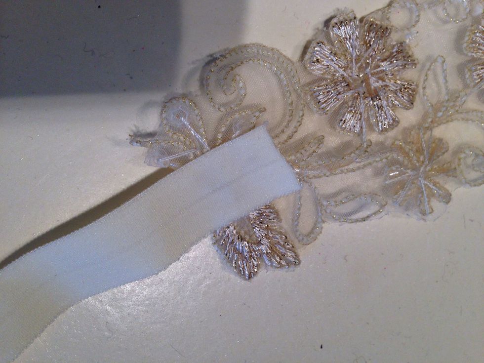 Adhere about 1/2 inch of the elastic to the ends of your ribbon.