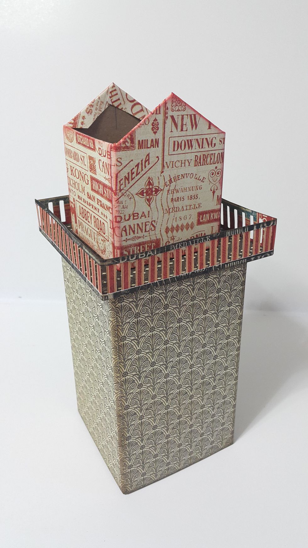 Adhere all parts together, then cut papers with the same size of the chipboard, plus one more 3"x3" to cover the insides of this upper tower.