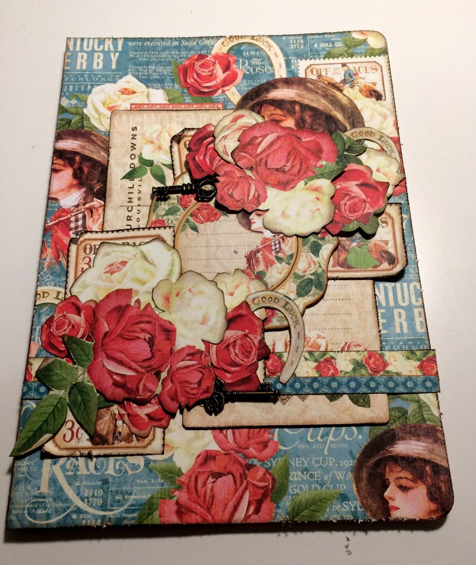 Adhere an ornate key in the top left hand corner in amongst the roses. Adhere the second ornate key in the bottom right hand corner in amongst the roses.