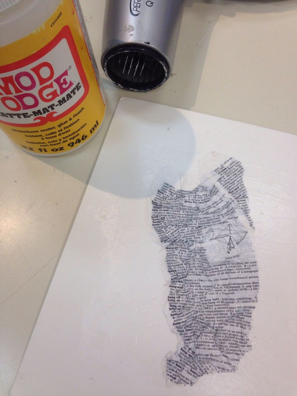 Adhere book paper to mat board with Modge podge. Coat the top to seal the surface. Allow wrinkles to remain and create a textured surface. Let the Modge podge dry.