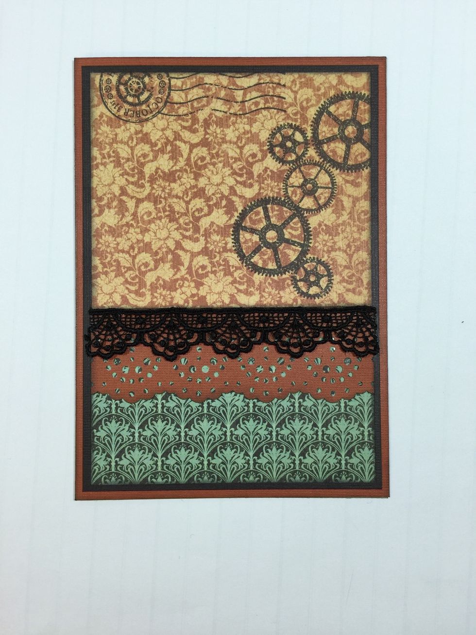 Adhere border-punched orange cardstock piece and black lace across card as shown.