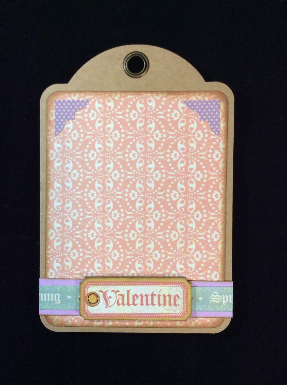 Adhere border unit to tag aligning approximately 1/4 inch from the edge. Glue embellishment centrally on to border strip. And position corner stickers if desired.