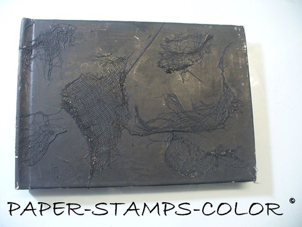 Adhere cheesecloth to the book (front and back cover. Paint the front with black gesso, and the back with white. We will do the front cover first.