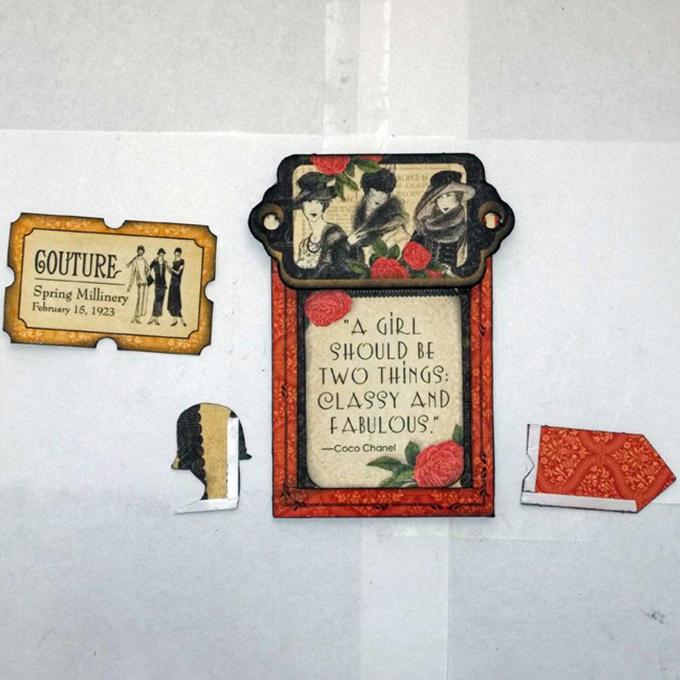Adhere chipboard at top of ATC Pocket and image cut from tags in centre. Use 1/8 in. Scor-Tape at outside edges of tag and fussy-cut piece so ticket can tuck in behind them.
