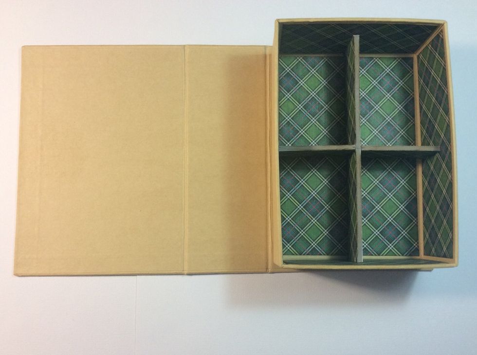 Adhere covered chipboard into the book box in an equal cross formation