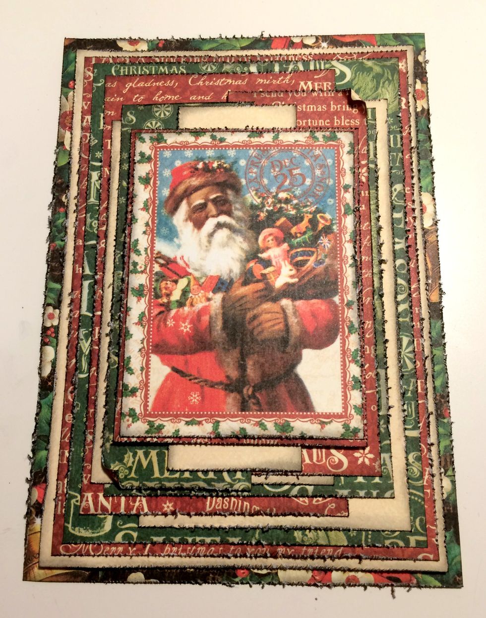 Adhere cream paper strip to red & green word strips. Adhere the St.Nick card to the red word paper. Foam square the red paper to the middle of the card. Roll corners down on the red & green strips.