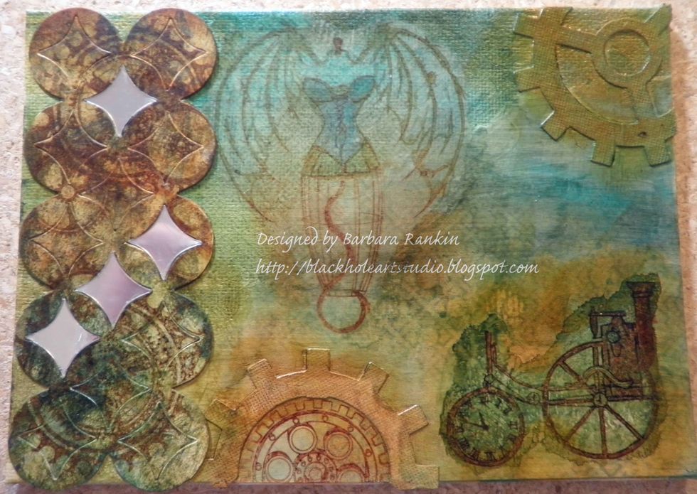 Adhere die cut to left side of canvas with matte medium or glue. Add centers from mirror sheet die cut to openings.