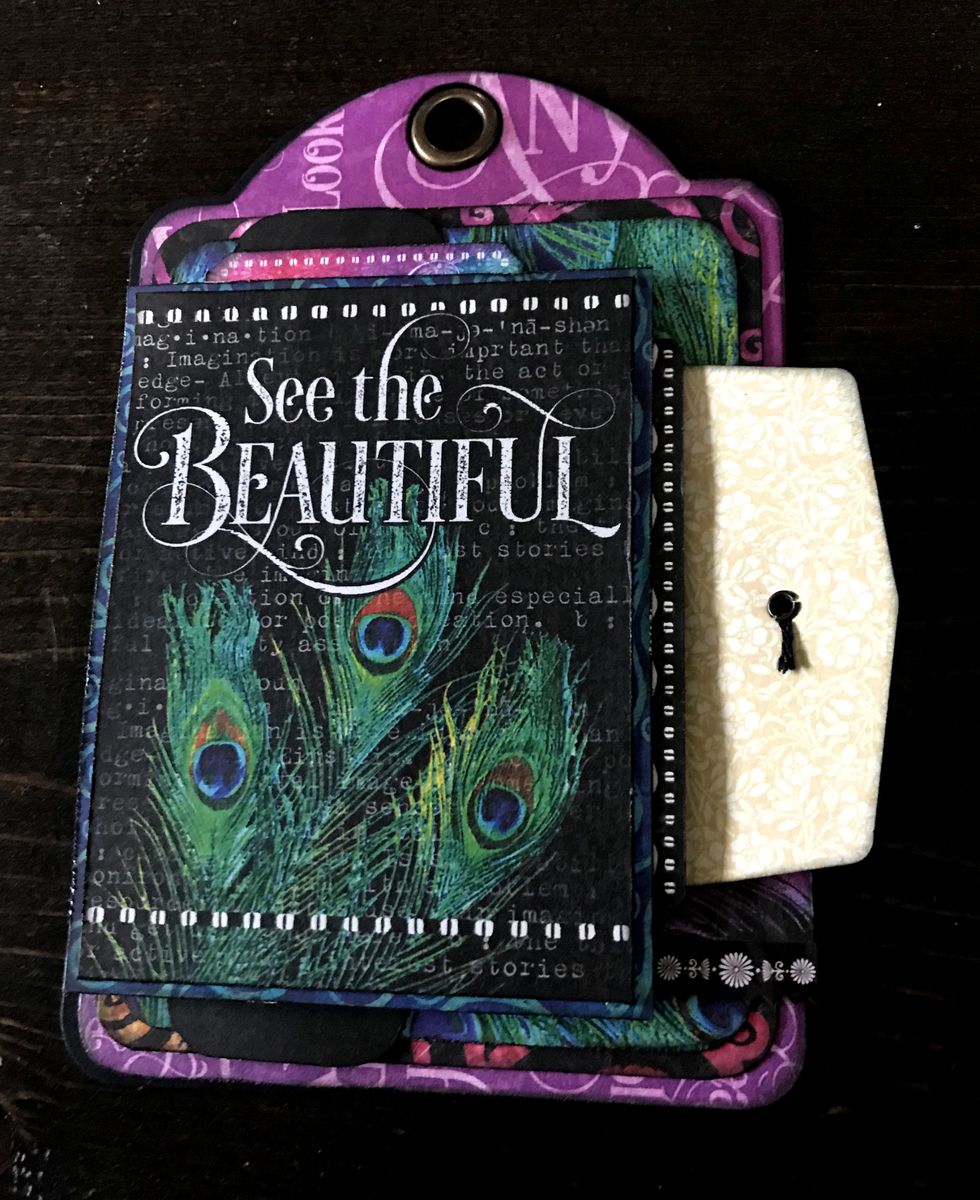 Adhere envelope 1/4" from left & 1 1/8" from top of tag. Adhere see the card to 3" patterned paper. Foam square 3" paper 1/8" from left & 3/8" from bottom of tag.