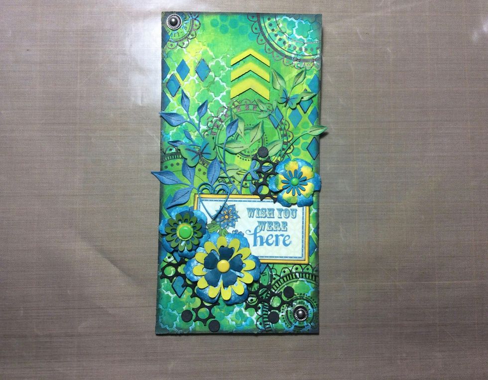 Adhere flowers, circle mesh and studs to the back ground. Your cover tag is now complete.