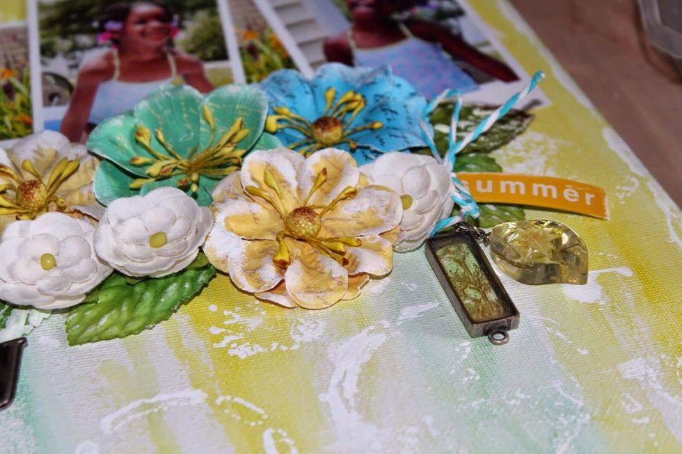 Adhere flowers, twine, bows, and charms to canvas using Xyron 3/8 adhesive dots and hot glue.
