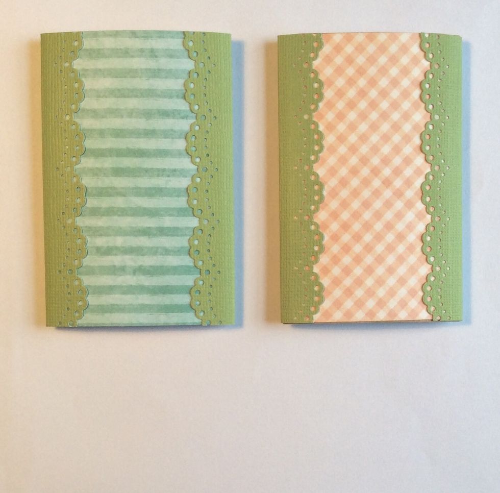 Adhere folded punched strips on long sides of matted tube pages. These strips will cover the exposed edges.