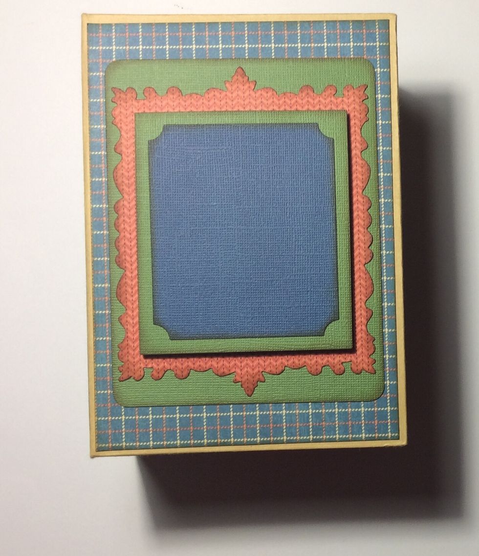 Adhere frame unit centrally to the front of the book box