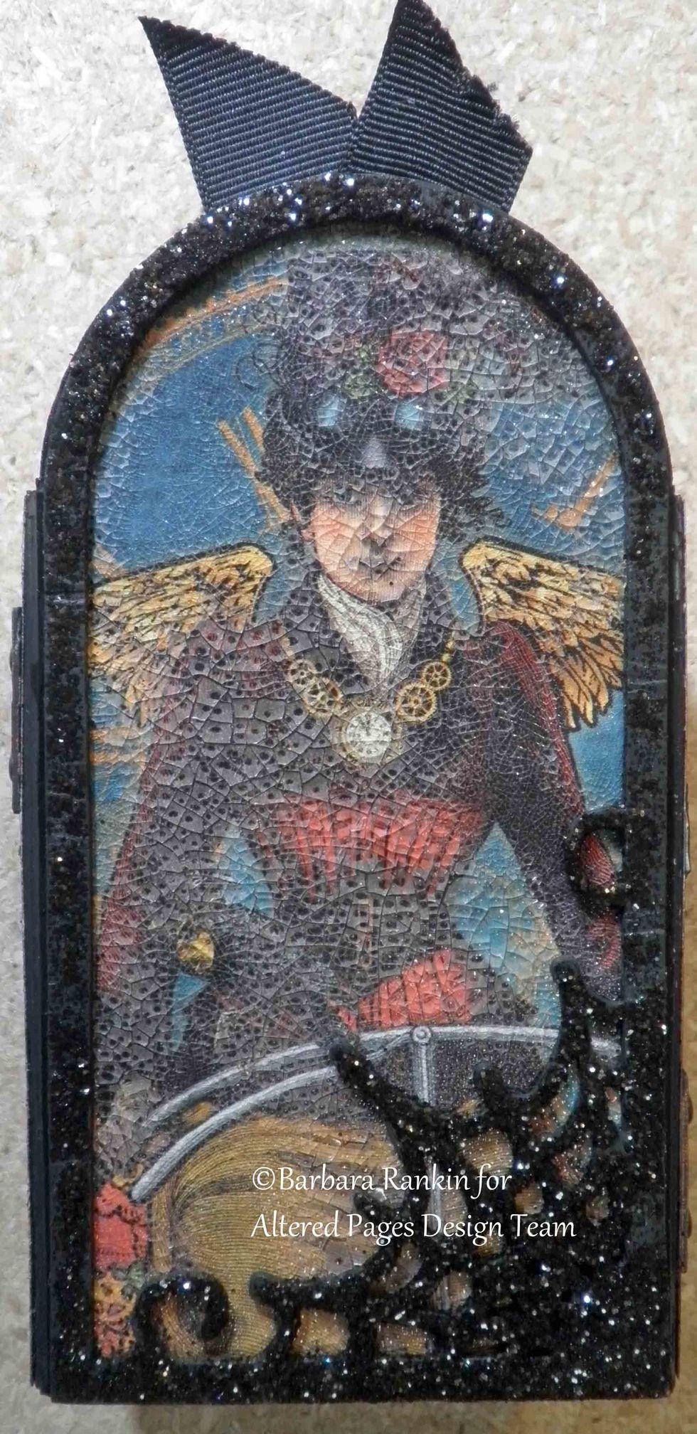 Adhere framed piece to back center panel of book. Here, you can see the great crackle effect. I find I get better results applying the crackle paint with my finger rather than a brush.