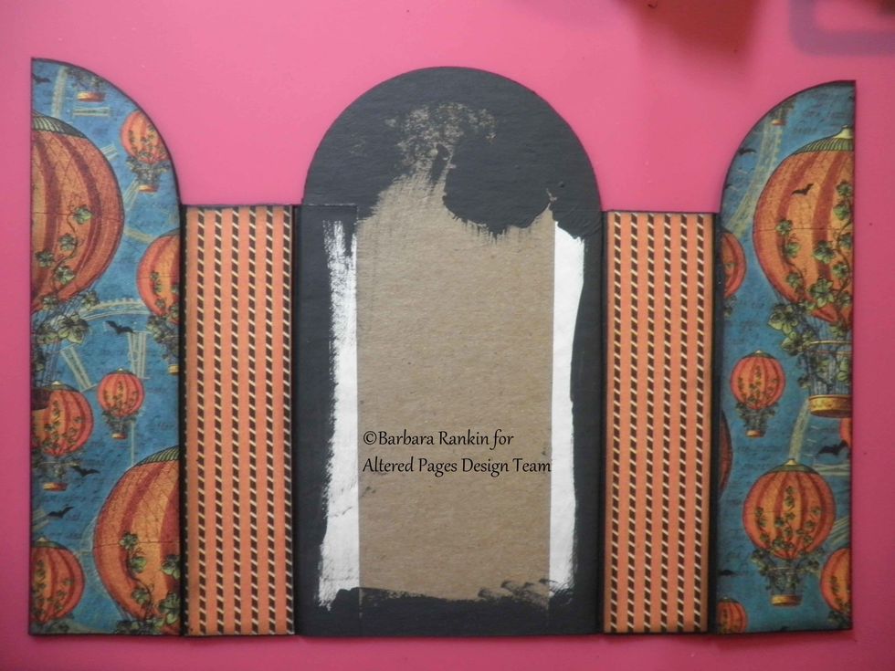 Adhere Graphic 45 papers to front door panels and spines on the outside, as shown. Run each paper piece through your Xyron. Leave center panel blank for now. This will be decorated last.