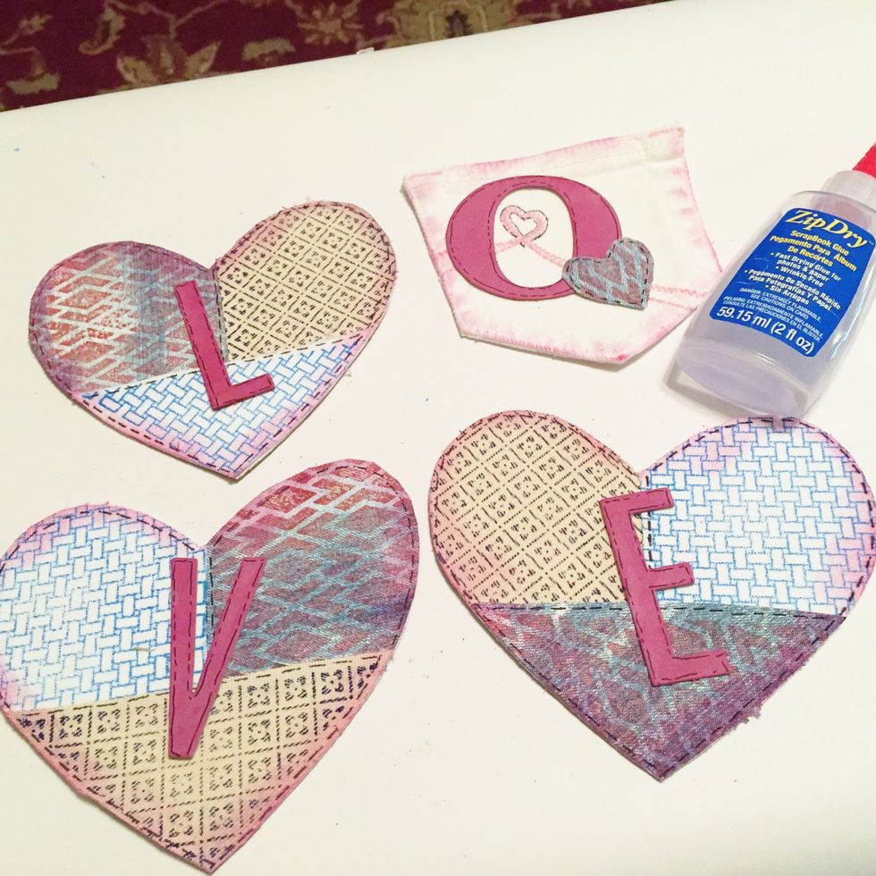 adhere letters to hearts and pocket.