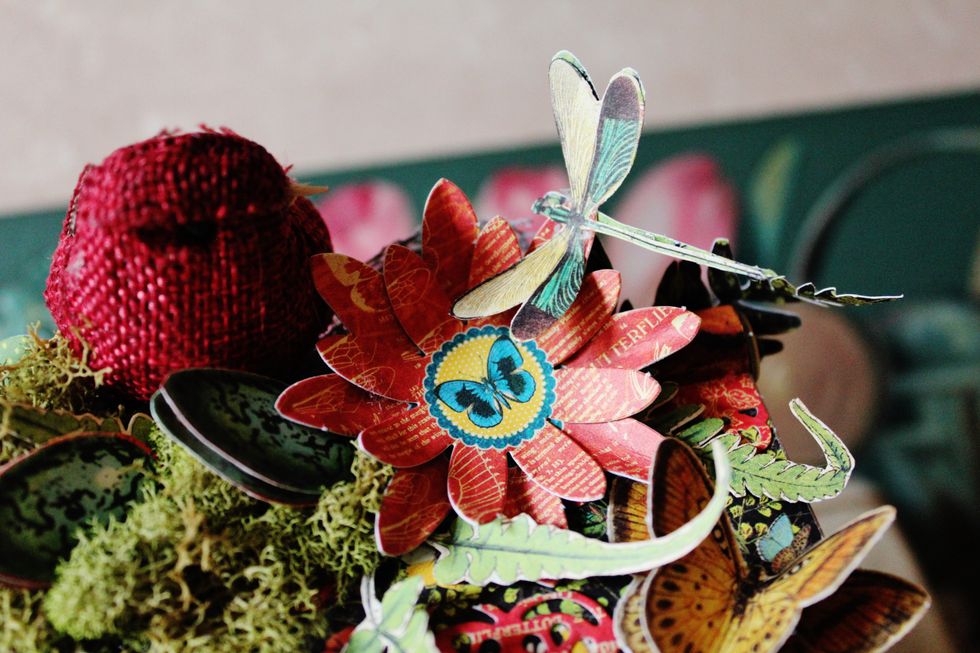 Adhere moss to top of birdhouse. Add rolled flower and fussy cut dragon fly to top of birdhouse