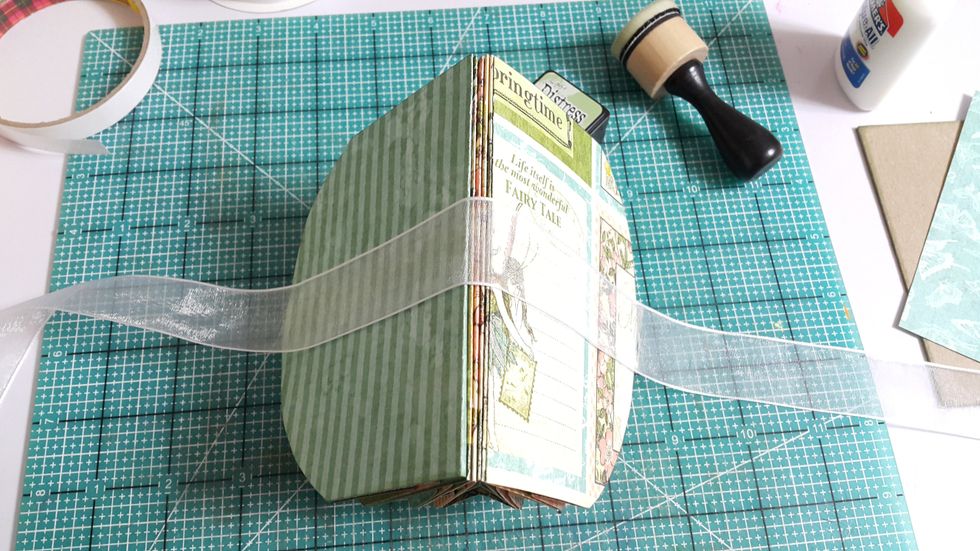 Adhere one ribbon across at the back