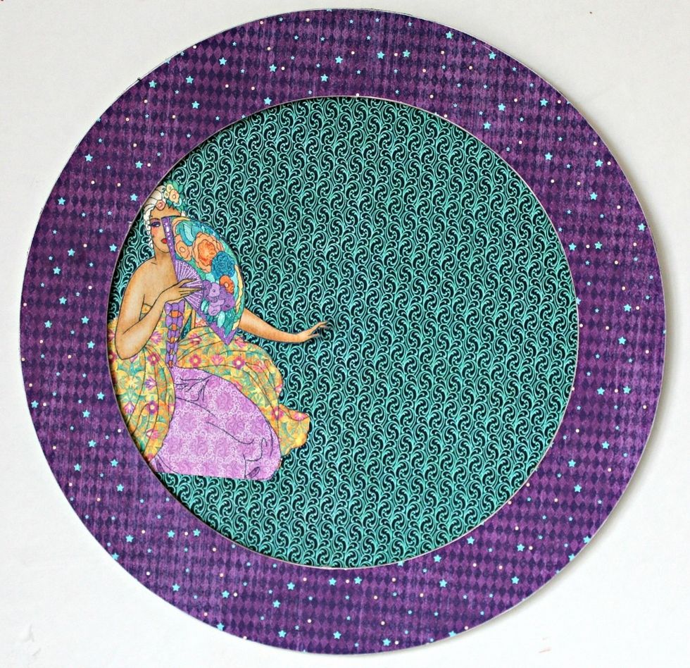 Adhere pattern paper to top of wreath, sand of. Adhere fussy cut image and pattern paper to back of wreath.