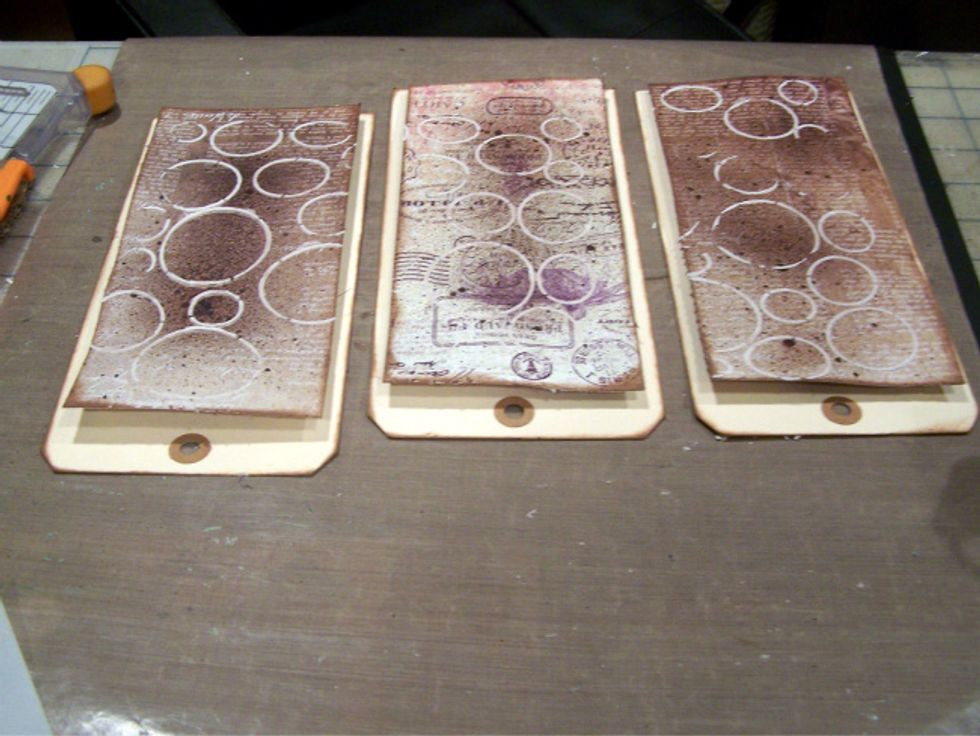 Adhere patterned paper to tags.