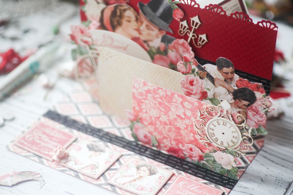 Adhere picture frames and embelishments to the stripes. Don't adhere one element to several stripes. Make sure all important elements are visible when the layout is open.