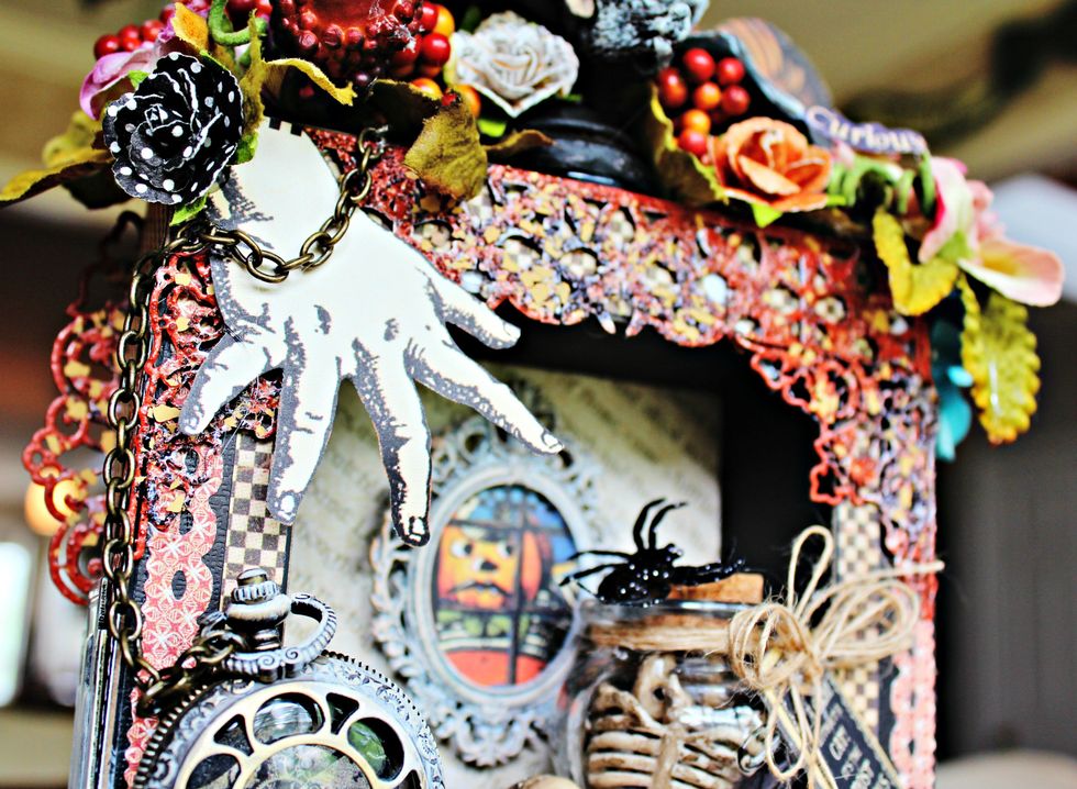 Adhere prepared embossed chipboard to top of hall tree. Fussy cut hand from pattern paper. Add to front of hall tree with pop dots.