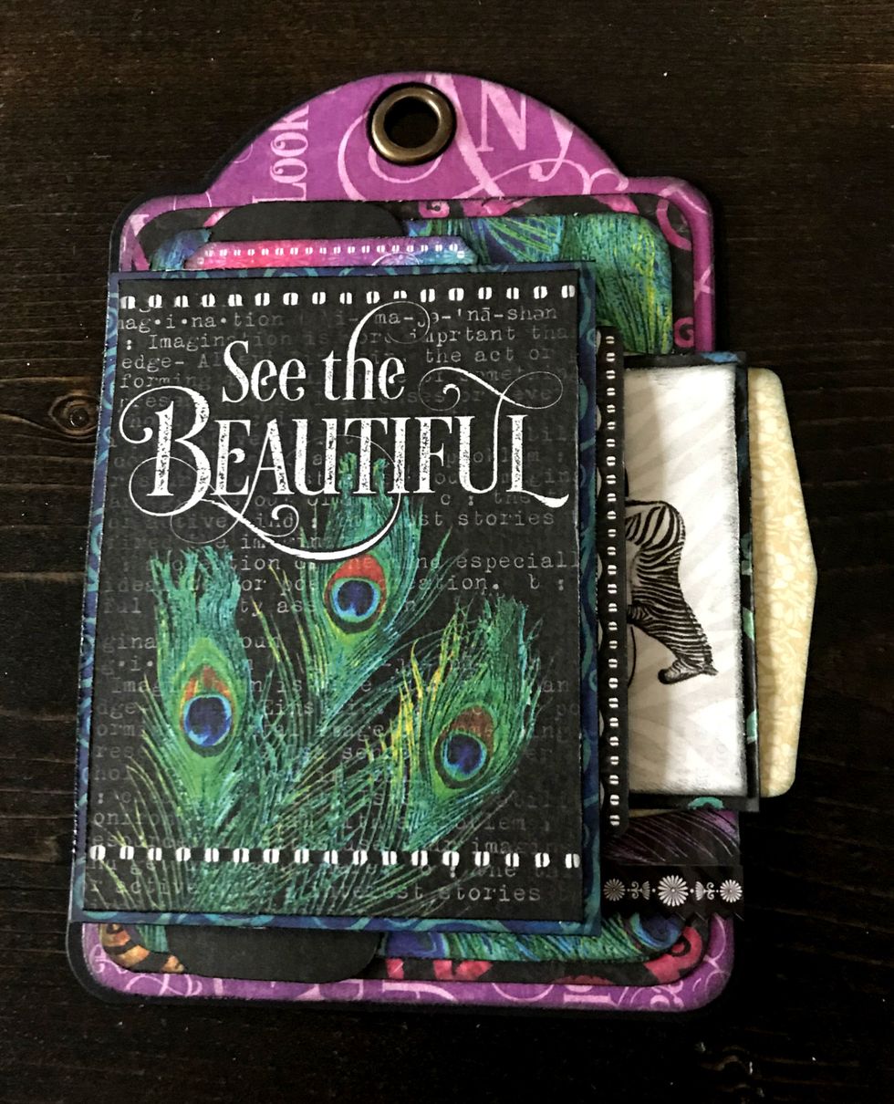 Adhere rainbow piece above see the card. Adhere 2 3/4" strip partially under 3" paper. Adhere zebra card to 2 5/8" patterned paper. Slide zebra card into envelope.