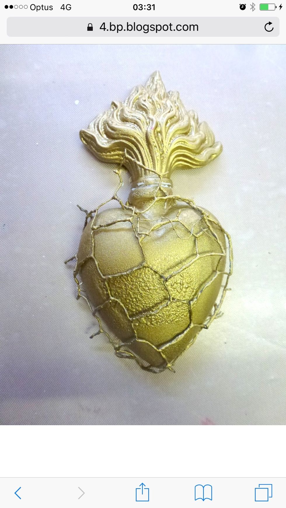 Adhere resin heart and flame to a solid grey board background, and adhere chicken wire, using strong clear drying glue; Or if you have it, use fine gold wire and tie it on at backside of heart resin.