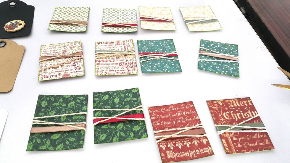 Adhere ribbons and twine on the paper randomly