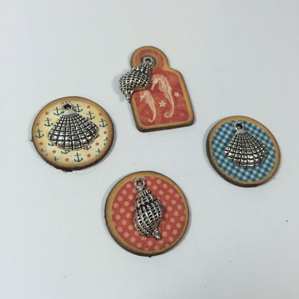 Adhere small charms to the chipboard pieces. I use E6000 adhesive.