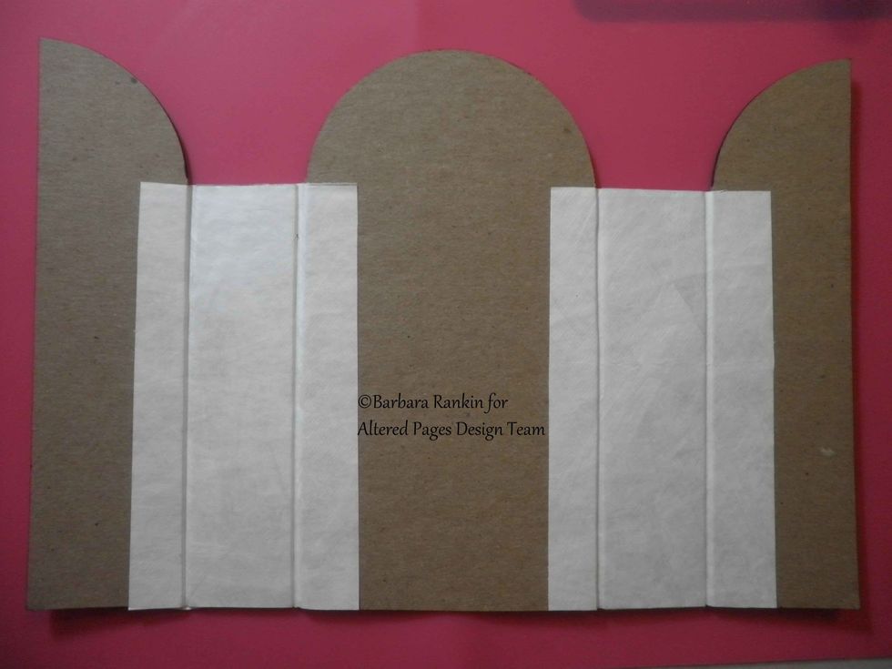 Adhere spine pieces to covers using 2-\u00bd" x 4-\u00bd" strips of Tyvek (or card stock) with Tacky Glue, on both the inside and outside. Leave a gap between chipboard pieces for flexibility.