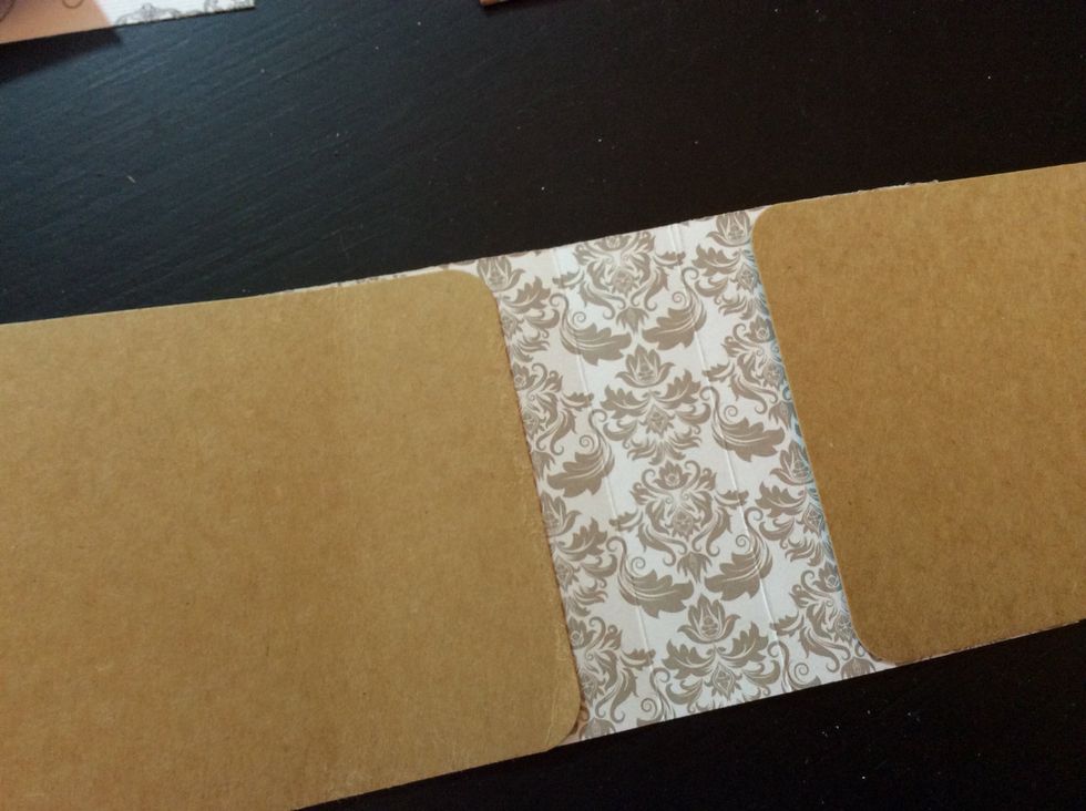 Adhere spine to the center of 2 tags, making sure to leave a 3/4" gap on both sides of the spine. This accommodates the envelopes we created. You can also use the envelope placed inside as a guide.