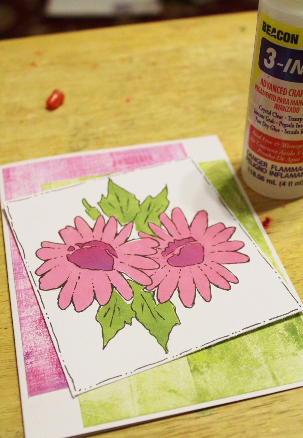 adhere stenciled flower piece at an angle to card front...