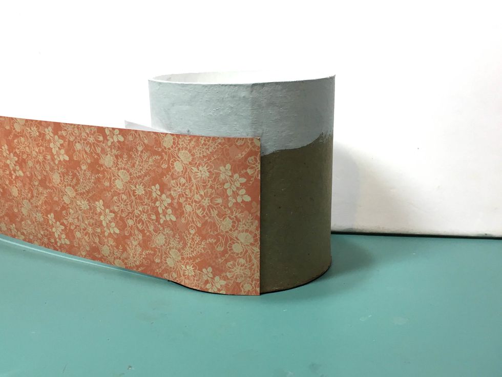 Adhere the 3"x 12" paper to the box, lining up at the bottom, so that the painted surface shows. The top portion of the box is not covered w/paper because the lid will not fit if the top is covered.