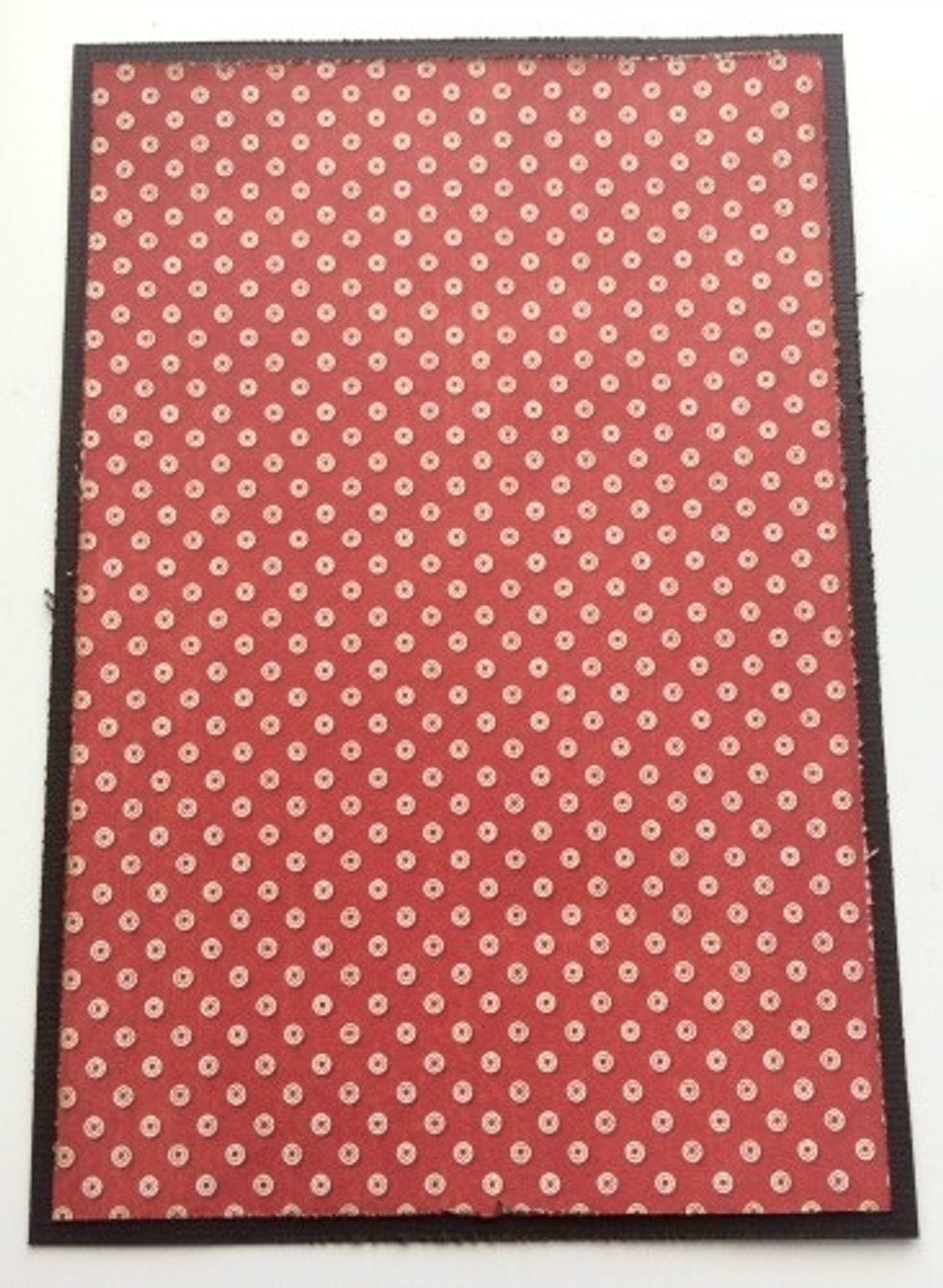 Adhere the 4" x 6" piece of red and white dot paper to the brown cardstock.